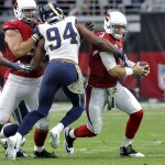 Arizona Cardinals quarterback Carson Palmer (3) is sacked by St. Louis Rams defensive end Robert Quinn (94) during the first half of an NFL football game, Sunday, Nov. 9, 2014, in Glendale, Ariz. (AP Photo/Ross D. Franklin)