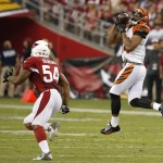  Cincinnati Bengals' Jermaine Gresham, right, makes a jumping catch in front of Arizona Cardinals' Kenny Demens (54) during the first half of an NFL preseason football game Sunday, Aug. 24, 2014, in Glendale, Ariz. (AP Photo/Ross D. Franklin)