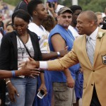 Hall of Fame Inductee Aeneas Williams greets fans as he is introduced during the 2014 Pro Football Hall of Fame Enshrinement Ceremony at the Pro Football Hall of Fame Saturday, Aug. 2, 2014, in Canton, Ohio. (AP Photo/Tony Dejak)