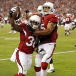 Arizona Cardinals running back Stepfan Taylor (30) celebrates his touchdown catch with teammate Michael Floyd during the second half of an NFL football game against the San Diego Chargers, Monday, Sept. 8, 2014, in Glendale, Ariz. (AP Photo/Ross D. Franklin)