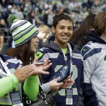Nate Hatch, second from right, a student who was injured in an October 2014 shooting at Marysville-Pilchuck high school in Marysville, Wash., stands with his mother Denise Hatch, left, and friends Eimily Oaks, second from left, and Kakota Hayes, right, during pre-game activities before an NFL football game between the Seattle Seahawks and the Arizona Cardinals, Sunday, Nov. 23, 2014, in Seattle. (AP Photo/Elaine Thompson)
