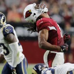 Arizona Cardinals wide receiver Larry Fitzgerald (11) reacts after a gain against the St. Louis Rams during the second half of an NFL football game, Sunday, Nov. 9, 2014, in Glendale, Ariz. (AP Photo/Rick Scuteri)