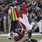 Arizona Cardinals wide receiver Jaron Brown (13) flips after being hit by St. Louis Rams' E.J. Gaines during the first half of an NFL football game Thursday, Dec. 11, 2014 in St. Louis. (AP Photo/Tom Gannam)