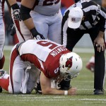 Arizona Cardinals quarterback Drew Stanton (5) is checked on by referee Gene Steratore after being knocked down late in the second half of an NFL football game against the Seattle Seahawks, Sunday, Nov. 23, 2014, in Seattle. The Seahawks won 19-3. (AP Photo/Elaine Thompson)