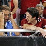 An Arizona Cardinals fan, right, cheers a game-winning touchdown while a San Diego Chargers fan reacts during the second half of an NFL football game, Monday, Sept. 8, 2014, in Glendale, Ariz. The Cardinals won 18-17. (AP Photo/Ross D. Franklin)
