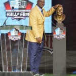 Hall of Fame inductee Derrick Brooks touches his bronze bust during the Pro Football Hall of Fame enshrinement ceremony Saturday, Aug 2, 2014, in Canton, Ohio. (AP Photo/David Richard)