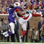  Arizona Cardinals wide receiver Larry Fitzgerald, right, catches a pass in front of Minnesota Vikings cornerback Marcus Sherels, left, during the first half of an NFL preseason football game, Saturday, Aug. 16, 2014, in Minneapolis. (AP Photo/Ann Heisenfelt)