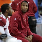 Injured Arizona Cardinals wide receiver Larry Fitzgerald looks at the scoreboard as he sits on the bench in the second half of an NFL football game against the Seattle Seahawks, Sunday, Nov. 23, 2014, in Seattle.The Seahawks won 19-3. (AP Photo/Stephen Brashear)