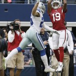 Arizona Cardinals wide receiver Ted Ginn (19) makes a reception over Dallas Cowboys defensive back Sterling Moore (26) during the second half of an NFL football game Sunday, Nov. 2, 2014, in Arlington, Texas. (AP Photo/Brandon Wade)