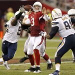 Arizona Cardinals quarterback Carson Palmer (3) is hurried by San Diego Chargers outside linebacker Dwight Freeney, left, during the second half of an NFL football game, Monday, Sept. 8, 2014, in Glendale, Ariz. The Cardinals won 18-17. (AP Photo/Ross D. Franklin)