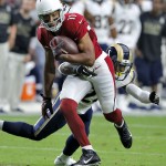 Arizona Cardinals wide receiver Larry Fitzgerald (11) runs as St. Louis Rams free safety Rodney McLeod defends during the first half of an NFL football game, Sunday, Nov. 9, 2014, in Glendale, Ariz. (AP Photo/Rick Scuteri)
