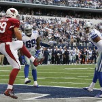 Arizona Cardinals tight end John Carlson (89) makes a touchdown reception against the Dallas Cowboys as defensive tackle Henry Melton (69) and free safety Barry Church (42) look on during the first half of an NFL football game Sunday, Nov. 2, 2014, in Arlington, Texas. (AP Photo/Sue Ogrocki)