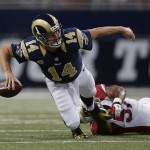 St. Louis Rams quarterback Shaun Hill (14) throws an incomplete pass as he is tackled by Arizona Cardinals outside linebacker Alex Okafor (57) during the first half of an NFL football game Thursday, Dec. 11, 2014 in St. Louis. (AP Photo/Jeff Roberson)