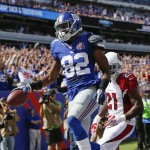 New York Giants wide receiver Rueben Randle (82) reacts after catching a pass for a touchdown in front of Arizona Cardinals' Patrick Peterson (21) during the first half of an NFL football game Sunday, Sept. 14, 2014, in East Rutherford, N.J. (AP Photo/Kathy Willens)