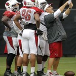 Arizona Cardinals offensive assistant David Diaz-Infante holds up the play chart during football camp practice, Monday, Aug. 18, 2014, in Glendale, Ariz. (AP Photo/Matt York)