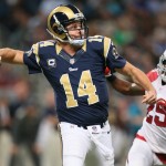 St. Louis Rams quarterback Shaun Hill throws while being pursued by Arizona Cardinals cornerback Jerraud Powers in the second quarter of an NFL football game, Thursday, Dec. 11, 2014 in St. Louis. Arizona won 12-6. (AP Photo/St. Louis Post-Dispatch, Chris Lee)