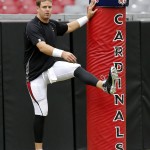 Arizona Cardinals' quarterback Carson Palmer stretches during football camp practice, Monday, Aug. 18, 2014, in Glendale, Ariz. (AP Photo/Matt York)