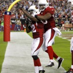 Arizona Cardinals wide receiver John Brown (12) celebrates his touchdown with teammate Jonathan Dwyer (20) against the San Diego Chargers during the second half of an NFL football game, Monday, Sept. 8, 2014, in Glendale, Ariz. (AP Photo/Rick Scuteri)