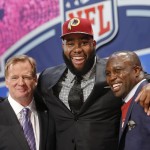 Virginia tackle Morgan Moses poses for photos with NFL commissioner Roger Goodell and former Washington Redskins' linebacker London Fletcher after being selected as the 66th pick during the third round of the 2014 NFL Draft, Friday, May 9, 2014, in New York. (AP Photo/Jason DeCrow)