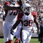Arizona Cardinals running back Stepfan Taylor (30) celebrates with tackle Bobby Massie (70) after scoring on a 2-yard touchdown reception against the Oakland Raiders during the first quarter of an NFL football game in Oakland, Calif., Sunday, Oct. 19, 2014. (AP Photo/Ben Margot)