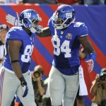 New York Giants tight end Larry Donnell (84) celebrates with Daniel Fells (85) after Fells caught a pass for a touchdown during the second half of an NFL football game against the Arizona Cardinals on Sunday, Sept. 14, 2014, in East Rutherford, N.J. (AP Photo/Bill Kostroun)

