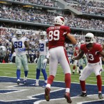 Arizona Cardinals tight end John Carlson (89) celebrates with wide receiver Jaron Brown (13) after making a touchdown reception against the Dallas Cowboys during the first half of an NFL football game Sunday, Nov. 2, 2014, in Arlington, Texas. (AP Photo/Sue Ogrocki)