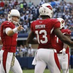 Arizona Cardinals quarterback Carson Palmer (3), center celebrates with wide receiver Jaron Brown (13) after Brown's touchdown reception against the Dallas Cowboys during the first half of an NFL football game Sunday, Nov. 2, 2014, in Arlington, Texas. (AP Photo/Sue Ogrocki)