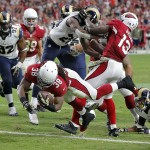 Arizona Cardinals running back Andre Ellington (38) leaps into the end zone for a touchdown as St. Louis Rams free safety Rodney McLeod (23) defends during the first half of an NFL football game, Sunday, Nov. 9, 2014, in Glendale, Ariz. (AP Photo/Rick Scuteri)