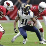 St. Louis Rams wide receiver Tavon Austin (11) tries to avoid Arizona Cardinals' Alex Okafor and Jerraud Powers (25) during the first half of an NFL football game, Sunday, Nov. 9, 2014, in Glendale, Ariz. (AP Photo/Rick Scuteri)