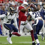 Arizona Cardinals wide receiver Michael Floyd (15) makes a catch as St. Louis Rams' Mark Barron (26) and Janoris Jenkins close in during the first half of an NFL football game, Sunday, Nov. 9, 2014, in Glendale, Ariz. (AP Photo/Rick Scuteri)