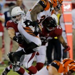 Cincinnati Bengals running back Jeremy Hill is stopped by Arizona Cardinals linebacker Glenn Carson (56) and Teddy Williams (29) during the second half of an NFL preseason football game, Sunday, Aug. 24, 2014, in Glendale, Ariz. (AP Photo/Rick Scuteri)