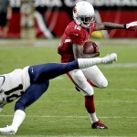 Arizona Cardinals wide receiver John Brown (12) eludes the tackle of St. Louis Rams cornerback Janoris Jenkins (21) during the second half of an NFL football game, Sunday, Nov. 9, 2014, in Glendale, Ariz. (AP Photo/Ross D. Franklin)