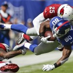 Arizona Cardinals cornerback Jerraud Powers (25) tackles New York Giants wide receiver Victor Cruz (80) during the first half of an NFL football game Sunday, Sept. 14, 2014, in East Rutherford, N.J. (AP Photo/Kathy Willens)