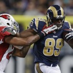 St. Louis Rams' Jared Cook (89) is tackled by Arizona Cardinals' Rashad Johnson (26) during the second half of an NFL football game Thursday, Dec. 11, 2014 in St. Louis. (AP Photo/Jeff Roberson)