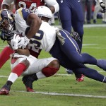 St. Louis Rams running back Benny Cunningham (36) scores a 3-yard touchdown as Arizona Cardinals strong safety Tony Jefferson defends during the first half of an NFL football game, Sunday, Nov. 9, 2014, in Glendale, Ariz. (AP Photo/Rick Scuteri)
