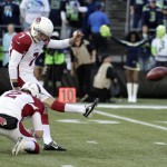 Arizona Cardinals kicker Chandler Catanzaro kicks a field goal as punter Drew Butler (2) holds against the Seattle Seahawks in the first half of an NFL football game, Sunday, Nov. 23, 2014, in Seattle. (AP Photo/Stephen Brashear)