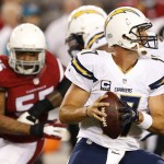 San Diego Chargers quarterback Philip Rivers (17) looks to pass under pressure from Arizona Cardinals outside linebacker John Abraham (55) during the first half of an NFL football game, Monday, Sept. 8, 2014, in Glendale, Ariz. (AP Photo/Ross D. Franklin)