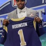 Auburn tackle Greg Robinson, right, poses with a St. Louis Rams jersey after being chosen as the second pick in the first round of the 2014 NFL Draft, Thursday, May 8, 2014, in New York.(AP Photo/Craig Ruttle)