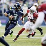 Seattle Seahawks quarterback Russell Wilson (3) scrambles for yardage as he is pursued by Arizona Cardinals strong safety Deone Bucannon (36) in the second half of an NFL football game, Sunday, Nov. 23, 2014, in Seattle. (AP Photo/Stephen Brashear)