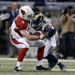 Arizona Cardinals quarterback Drew Stanton (5) is tackled by St. Louis Rams outside linebacker Alec Ogletree (52) during the first half of an NFL football game Thursday, Dec. 11, 2014 in St. Louis. (AP Photo/Jeff Roberson)
