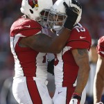Arizona Cardinals wide receiver Michael Floyd, right, celebrates after scoring on a 20-yard touchdown reception with tackle Bobby Massie during the first quarter of an NFL football game against the San Francisco 49ers in Santa Clara, Calif., Sunday, Dec. 28, 2014. (AP Photo/Tony Avelar)
