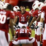 Arizona Cardinals wide receiver Larry Fitzgerald (11) runs towards Patrick Peterson (21) as he takes the field prior to an NFL football game against the San Diego Chargers, Monday, Sept. 8, 2014, in Glendale, Ariz. (AP Photo/Ross D. Franklin)