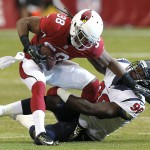 Arizona Cardinals running back Andre Ellington (38) is tackled by Houston Texans linebacker Jadeveon Clowney (90) during the first half of an NFL preseason football game, Saturday, Aug. 9, 2014, in Glendale, Ariz. (AP Photo/Ross D. Franklin)