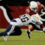 Arizona Cardinals running back Jonathan Dwyer (20) is hit by San Diego Chargers defensive back Brandon Flowers (26) during the first half of an NFL football game, Monday, Sept. 8, 2014, in Glendale, Ariz. (AP Photo/Matt York)