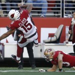 Arizona Cardinals wide receiver Michael Floyd (15) scores on a 41-yard touchdown reception over San Francisco 49ers strong safety Craig Dahl during the second quarter of an NFL football game in Santa Clara, Calif., Sunday, Dec. 28, 2014. (AP Photo/Tony Avelar)
