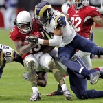 Arizona Cardinals wide receiver Ted Ginn (19) is hit by St. Louis Rams strong safety T.J. McDonald (25) during the first half of an NFL football game, Sunday, Nov. 9, 2014, in Glendale, Ariz. (AP Photo/Rick Scuteri)