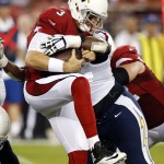 Arizona Cardinals quarterback Carson Palmer (3) is sacked by San Diego Chargers defensive end Corey Liuget during the first half of an NFL football game, Monday, Sept. 8, 2014, in Glendale, Ariz. (AP Photo/Ross D. Franklin)