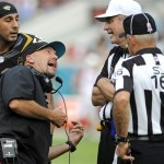 Jacksonville Jaguars head coach Gus Bradley, left, talks with officials Referee Jeff Triplett, second from right, and side judge Dave Wyant (16) during the second half of an NFL football game against the Arizona Cardinals in Jacksonville, Fla., Sunday, Nov. 17, 2013.(AP Photo/Stephen Morton)