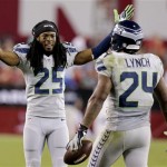 Seattle Seahawks cornerback Richard Sherman (25) greets teammate Marshawn Lynch (24) after Lynch scored a touchdown against the Arizona Cardinals during the second half of an NFL football game, Thursday, Oct. 17, 2013, in Glendale, Ariz. (AP Photo/Ross D. Franklin)