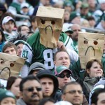 Spectators use bags over their heads while watching the first half of an NFL football game between the New York Jets and the Arizona Cardinals, Sunday, Dec. 2, 2012, in East Rutherford, N.J. (AP Photo/Bill Kostroun)
